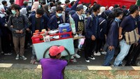 Seorang pedagang minuman menghentikan gerobaknya di area sekitar demo yang didatangi oleh mahasiswa dan sejumlah elemen masyarakat.