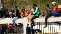 Warga dan mahasiswa bahu membahu membagikan air minum kepada para peserta aksi di depan gedung DPR, Jakarta.