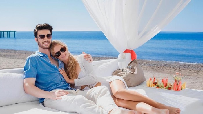 Romantic couple relaxing and enjoying on the beach