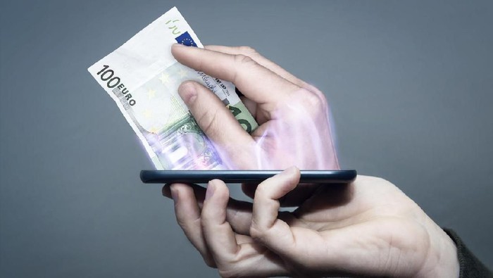 a hand hold a smart phone and pay with it.