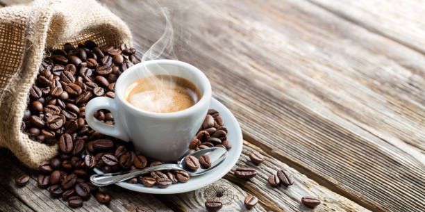 Roasted coffee beans, frozen grain in the air with shallow depth of field.