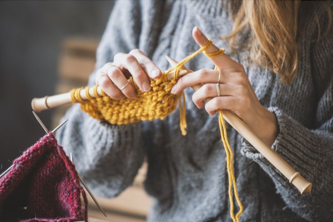 Close up on womans hands knitting