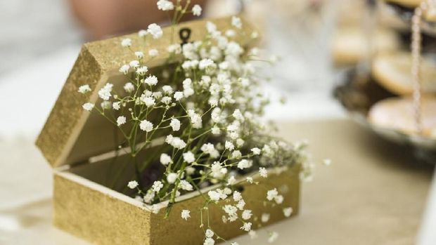 Close-up shot of bunch of baby's breath flowers in a box on the table.