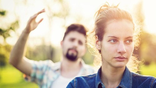 Couple is watching TV in the bed and the wife is unhappy with the channel