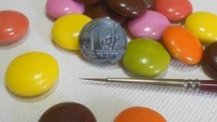 Adalah Hasan Kale yang mampu melukis di atas permukaan makanan yang mungil. Seperti pada lukisannya yang menggambarkan bangunan di atas permen cokelat ini. Foto: Hasan Kale
