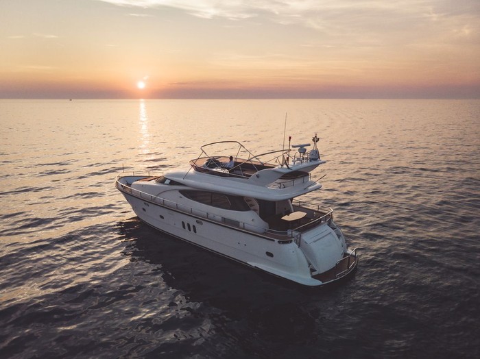Cruising across the ocean, cruising on a luxurious yacht, yacht with strong engine, sunset, seaside, holiday on deck, sweet life on deck, driving yacht across the coastline.