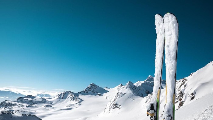 Panoramic view on snowcapped skis on the top of ski slope with view on the mountains. Val Thorens, France.
