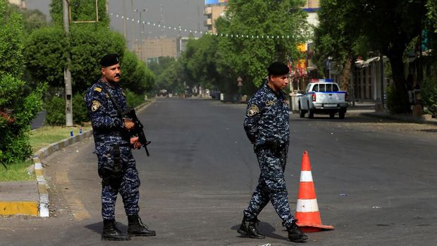 Pasukan keamanan Irak berjaga saat pemberlakukan jam malam di Baghdad