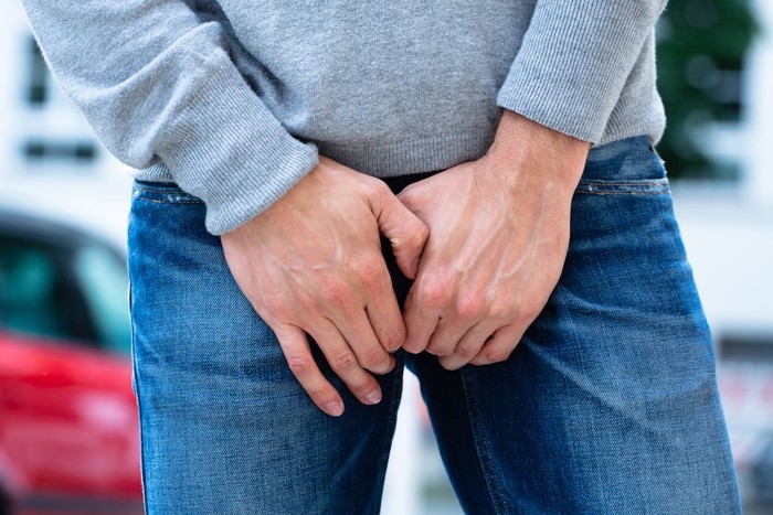 1013436466 Close-up Of A Mans Hand On His Crotch