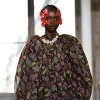Gaya yang ditampilkan oleh peragaan busana dari Giambattista Valli cukup menarik perhatian. Model yang tampil di Paris Fashion Week ini terlihat menggunakan kelopak bunga berwarna merah pada bagian wajahnya.Foto: Getty Images
