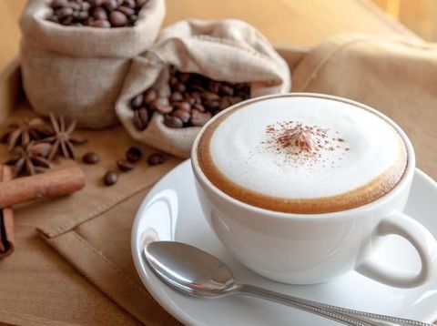 a cup of black coffee in hands