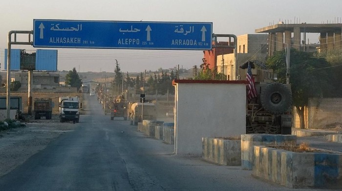In this image provided by Hawar News Agency, ANHA,  a line of U.S. military vehicles travel down a main road in northeast Syria, Monday, Oct. 7, 2019. U.S.-backed Kurdish-led forces in Syria said American troops began withdrawing Monday from their positions along Turkeys border in northeastern Syria, ahead of an anticipated Turkish invasion that the Kurds say will overturn five years of achievements in the battle against the Islamic State group. (ANHA via AP)