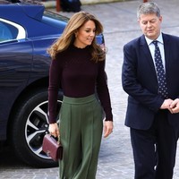 Kate Middleton muncul dalam balutan atasan burgundy bergaya sweater dari label Warehouse yang dijual seharga 39 pound sterling atau Rp 675 ribu. Atasan tersebut hadir dengan kerah tinggi bergelembang yang menciptakan kesan elegan. Foto: Getty Images