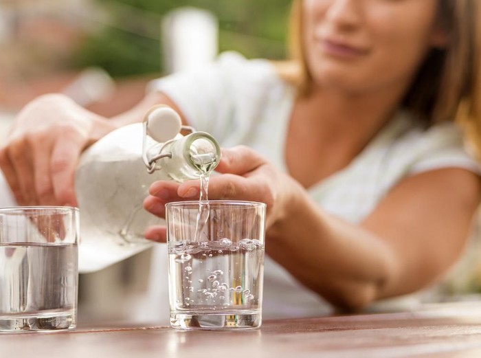 Air Putih Pouring water in glass, Refreshments at coffee bar, Water pouring from bottle into the glass
