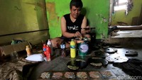 Seorang pekerja sedang memberi warna souvenir berbahan dasar kayu tersebut.