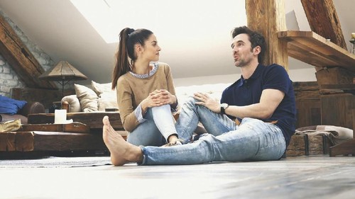 A shot of a simple, but beautiful moment between two people talking to each other at home.