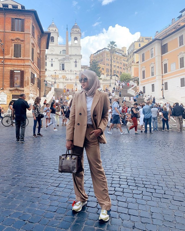Liburan ke Italia, Olla Ramlan tampil fashionable dengan setelan blazer dan menenteng tas Hermes Birkin Bordeaux Porosus Crocodile Gold Hardware 30 cm. Tas mewahnya tersebut seharga US$ 77.950 atau sekitar Rp 1,1 miliar.  Foto: Instagram