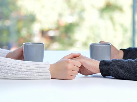 couple Close up of a couple hands dating and caressing in a bar or home interior