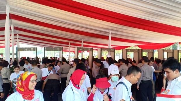Satu per satu relawan melewati metal detector.