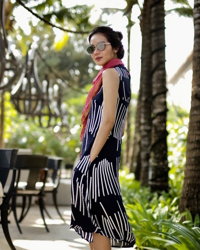 Berlibur ke Bali, wanita 32 tahun itu tampil dengan dress biru bermotif. Gista memadankannya dengan syal warna pink. Foto: dok. Instagram @gistaputri