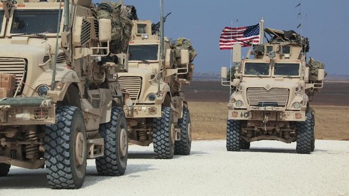 American military convoy stops near the town of Tel Tamr, north Syria, Sunday, Oct. 20, 2019. Kurdish-led fighters and Turkish-backed forces clashed sporadically Sunday in northeastern Syria amid efforts to work out a Kurdish evacuation from a besieged border town, the first pull-back under the terms of a U.S.-brokered cease-fire. (AP Photo/Baderkhan Ahmad)