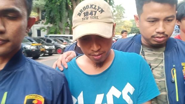 Shairil terus menunduk saat dibawa ke kantor polisi setelah diantar DKM Masjid Al-Falaah