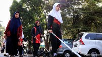 Para peserta berbaris rapi saat mengikuti aksi gerak jalan yang diselenggarakan untuk memperingati hari penglihatan sedunia dan hari tongkat putih.