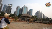 Warga nampak asyik menerbangkan layang-layang di langit Kota Jakarta yang nampak cerah.