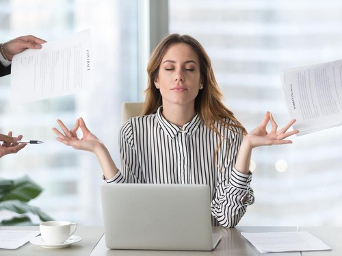Young woman preparing home budget, using laptop and calculator