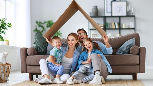 Shot of a young couple giving each other a high five while moving house