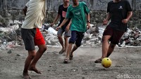 Sejumlah warga bermain bola di sekitar tumpukan sampah di kawasan Penjaringan, Jakarta Utara, Kamis (31/10).