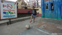 Beberapa anak menghabiskan waktu dengan bermain sepakbola.