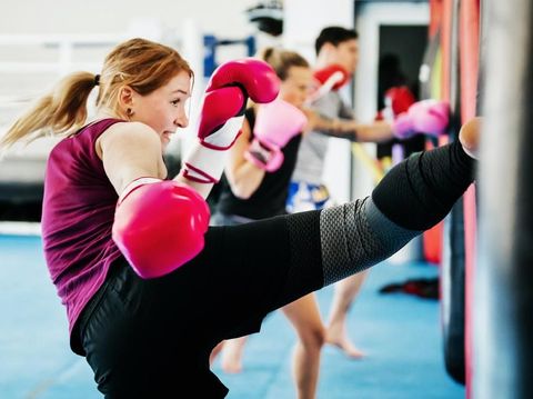 A group of women kickboxing and training together at their local gym.