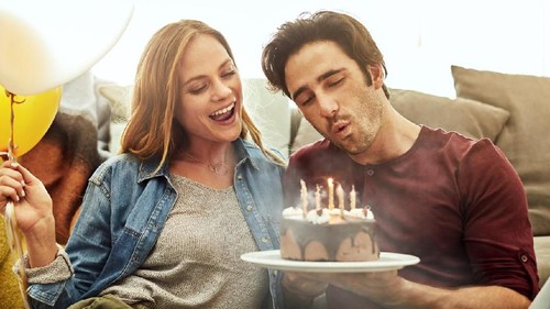 Shot of a young couple having cake while celebrating a birthday at home