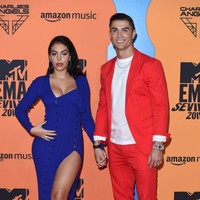 MTV EMAs 2019 juga dihadiri pesepakbola Cristiano Ronaldo dan kekasihnya, Georgia Rodriguez. Untuk ajang penghargaan musik tersebut, pemain Juventus itu mengandalkan setelan merah yang dipadu kaus dan sneakers putih. Tidak ketinggalan sebuah jam tangan sebagai statement. Sementara itu, Georgia hadir dalam balutan gaun biru seksi dengan belahan rok yang tinggi. (Foto: Getty Images)