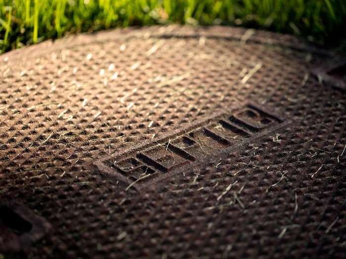 Closed septic tank cover in a backyard