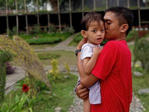 father with his girl suffering from cerebral palsy