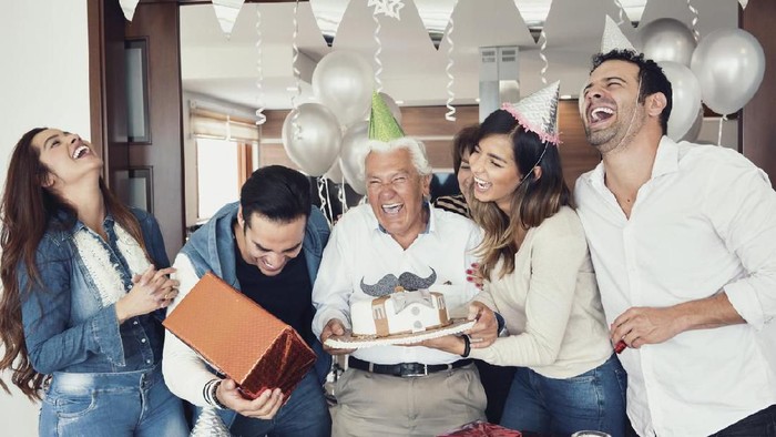 Latin family of different ages is reunited celebrating grandpas birthday