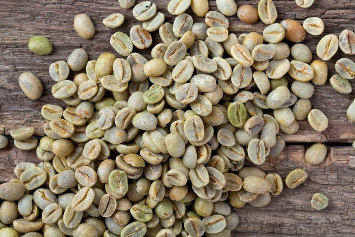 green coffee beans on wooden surfacegreen coffee beans on wooden surface