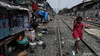 Seorang anak nampak melintasi rel kereta di kawasan Pademangan Barat, Jakarta Utara, Senin (11/11/2019).