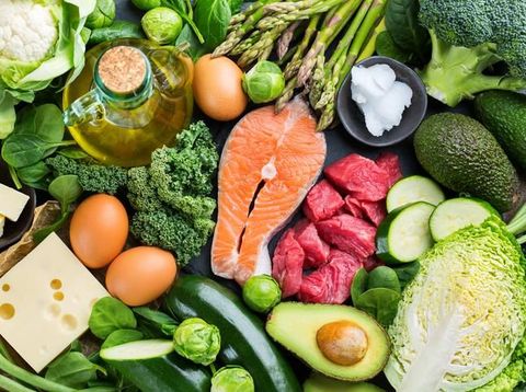 gizi seimbang Balanced diet nutrition keto concept. Assortment of healthy ketogenic low carb food ingredients for cooking on a kitchen table. Green vegetables, meat, salmon, cheese, eggs. Top view background