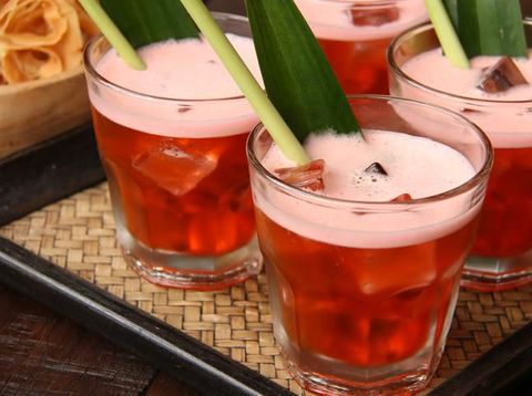 Bir Pletok, the traditional non-alcoholic beer from Betawi culture, Jakarta. The beer, that is basically a herbal concoction, is served with foam on top after being shaken with ice cubes. The beer is served in a old-fashioned glass filled with ice cubes and garnished with lemongrass and pandan leaf.