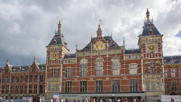Amsterdam, Netherlands - November 13, 2011: Passengers walk along one of the platforms at Amsterdams Central Station (Centraal Station, ASD), one of the largest and busiest stations in the Netherlands.