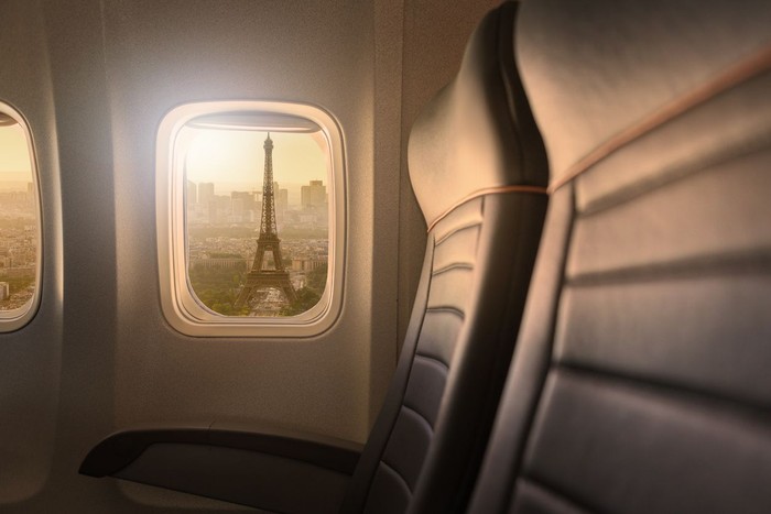 travel to Paris, view of Eiffel Tower from the window of airplane, holidays in France, Europe
