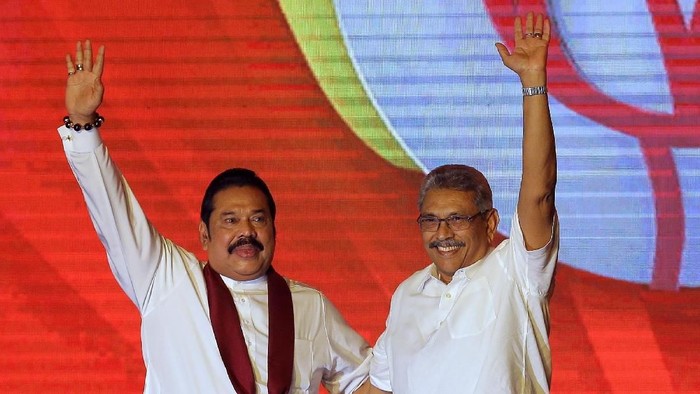 FILE - In this Aug. 11, 2019, file photo, former Sri Lankan President Mahinda Rajapaksa, left, and his brother and former Defense Secretary Gotabaya Rajapaksa wave to supporters during a party convention held to announce the presidential candidacy in Colombo, Sri Lanka. Rajapaksa is credited with helping end the countryâ€™s long civil war and is revered as a hero by the Sinhalese Buddhist majority. He comfortably won Saturdayâ€™s presidential election with about 52% of the ballots. But minorities largely voted for his opponent, fearing Rajapaksa because of allegations of wartime human rights violations against him. (AP Photo/Eranga Jayawardena, File)