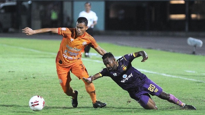 Pesepak bola Persik Kediri Romario Roberto Rumpaisum (kanan) berebut bola dengan pesepak bola Persiraja Eriyanto (kiri) saat pertandingan semi final Liga 2 2019 di Stadion Kapten I Wayan Dipta, Gianyar, Bali, Jumat (22/11/2019). ANTARA FOTO/Fikri Yusuf/pd.