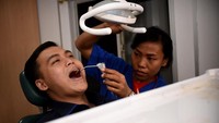 Seorang warga tengah memeriksakan kesehatan giginya di Rumah Sakit Apung (RSA) doctorSHARE. Istimewa/Dok. doctorSHARE.