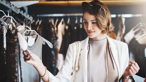 Smiling young woman walking in the city