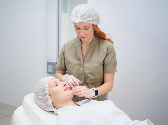 filler beauty doctor carries out cosmetological procedure injecting collagen filler to increase lips size