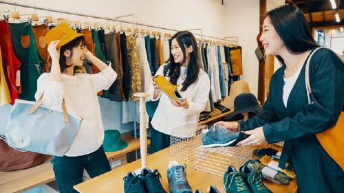 Three women shopping together in a clothing store in Japan